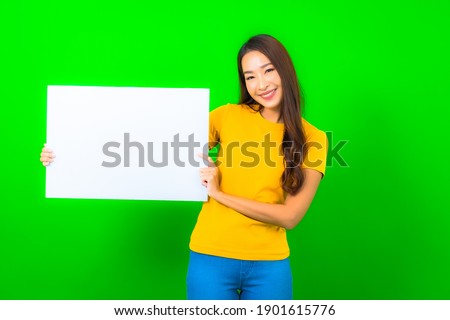 Portrait beautiful young asian woman show white empty billboard on green color background