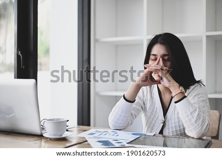 Businesswoman frustrated by business problem or work stress while sitting in office.