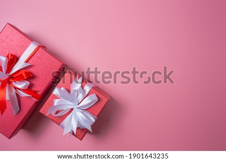 Red gift box with bow on red background top view, Valentines day, Flat lay style with copy space.
