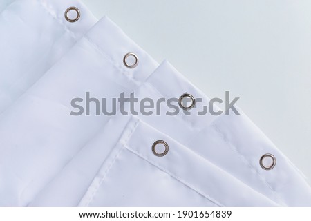 White shower curtain hooks, close up view. Top view. Royalty-Free Stock Photo #1901654839