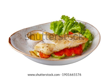 Halibut steak with vegetables isolated on white background.