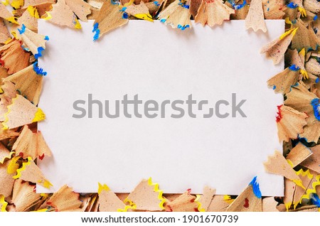 White sheet of paper and shavings of pencil around the perimeter - Baner of white color with paper for your inscription surrounded by scattered shavings from pencil - Paper with copy space for text