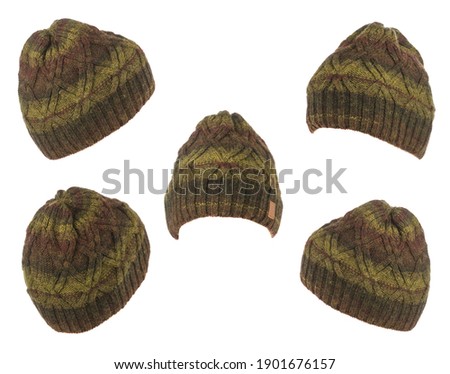 set of five knitted brown green hat isolated on white background .