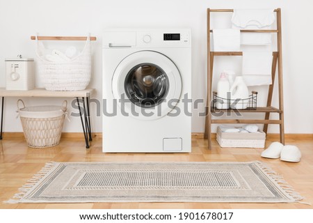 Domestic room with washing machine, baskets and laundry essential things Royalty-Free Stock Photo #1901678017