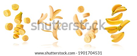 A set with Fresh ripe baby bananas with leaves falling in the air isolated on white background. Food levitation concept. High resolution image Royalty-Free Stock Photo #1901704531