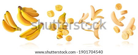 A set with Fresh ripe baby bananas with leaves falling in the air isolated on white background. Food levitation concept. High resolution image Royalty-Free Stock Photo #1901704540