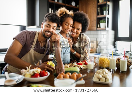 Happy family having fun together at home in the kitchen