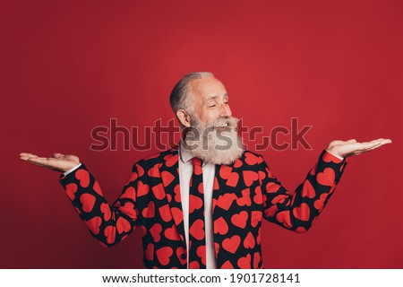 Photo of adviser man palms hold empty space look hand wear heart print tuxedo isolated red background