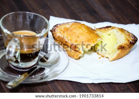 Classic Apulian breakfast in Salento, "Pasticciotto" of shortcrust pastry, sight filling of cream, on the side a cup of espresso. Royalty-Free Stock Photo #1901733814