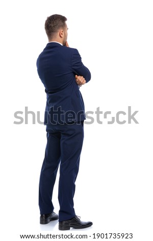 full picture body of thoughtful young man holding hand to chin and thinking, standing isolated on white background in studio