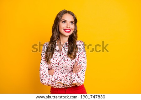 Photo of attractive lady folded arms look empty space thinking imagination isolated on yellow color background