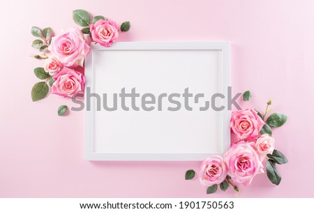 Happy women's day concept, pink roses with white picture frame on pastel background