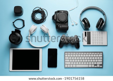 Different modern devices on color background Royalty-Free Stock Photo #1901756158