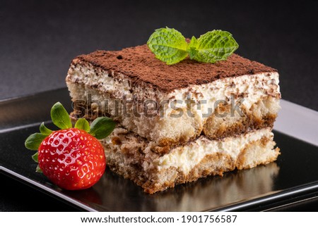 italian tiramisu with cocoa, mint and  strawberry Royalty-Free Stock Photo #1901756587