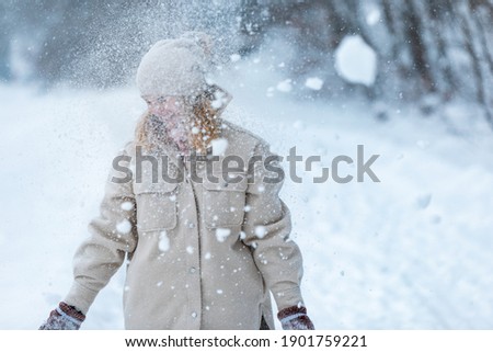 Happy girl playing with snow outdoor