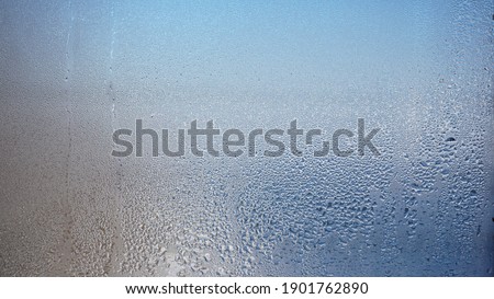 Glass with water vapor, fog, flow. a window with water drops. fogged glass  Royalty-Free Stock Photo #1901762890