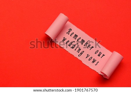 Remember our wedding vows label on torn paper with red paper background. Wedding And Valentine's Day Concept