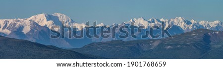 Large panorama. View of the snow-capped mountain range.