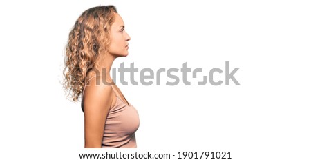 Beautiful caucasian woman wearing casual clothes looking to side, relax profile pose with natural face with confident smile. 