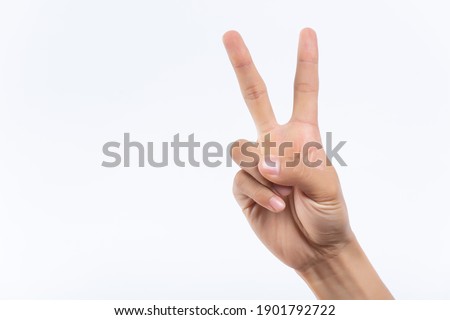 Closeup of isolated on green adult female hand counting from 0 to 5. Woman shows fist fist, then one, two, three, four, five fingers. Manicured nails painted with beautiful pink polish. Math concept. Royalty-Free Stock Photo #1901792722