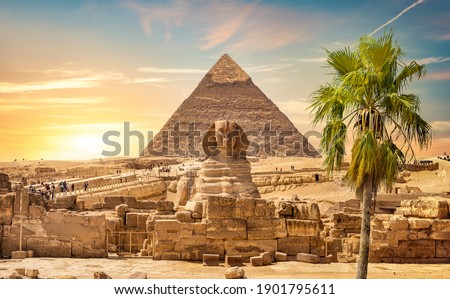 Great sphinx and pyramid under bright sun Royalty-Free Stock Photo #1901795611