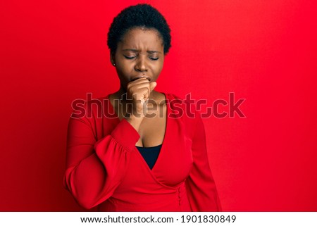 Young african woman with afro hair wearing casual clothes over red background feeling unwell and coughing as symptom for cold or bronchitis. health care concept. 