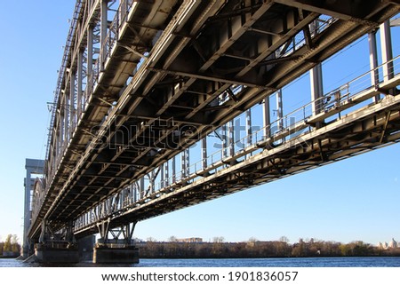 View from under the bridge on the two tracks of the railway bridge with four arched spans and a swinging center