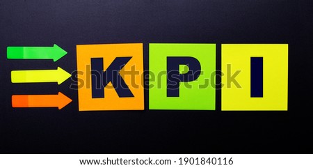 Bright multi-colored paper stickers on a black background with the text KPI