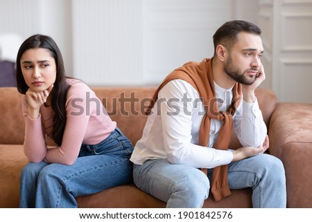Marital Problems. Unhappy Arab Couple Sitting Back-To-Back Not Talking After Quarrel On Couch At Home. Young Husband And Wife Thinking About Divorce Having Relationship Crisis Royalty-Free Stock Photo #1901842576