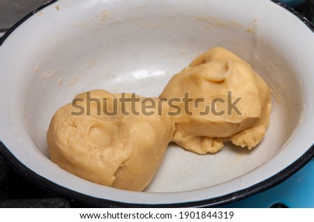 two pieces of raw dough in a bowl. High quality photo