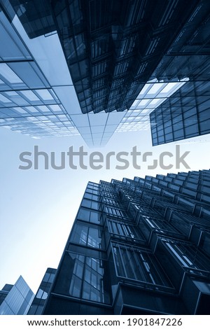 Panoramic bottom view and perspective of tall blue glass and steel business building skyscrapers colored in clear blue in London. Successful  business, opportunity, and challenge  concept. low angle Royalty-Free Stock Photo #1901847226