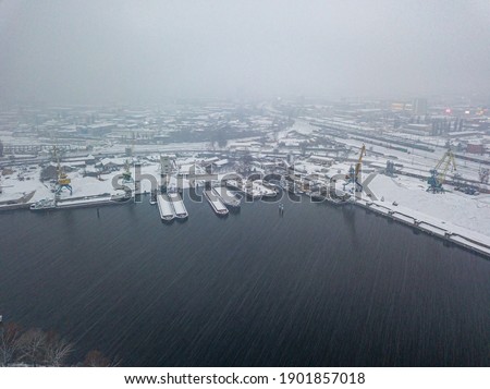 Blizzard in the industrial port. Snowy day, blizzard. Aerial drone view.