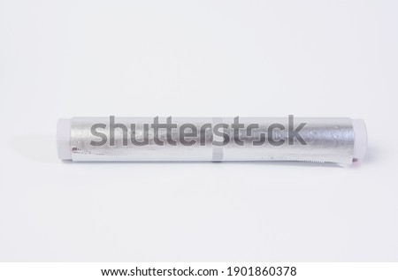 roll of gray foil for baking and packaging food on a white background, close up