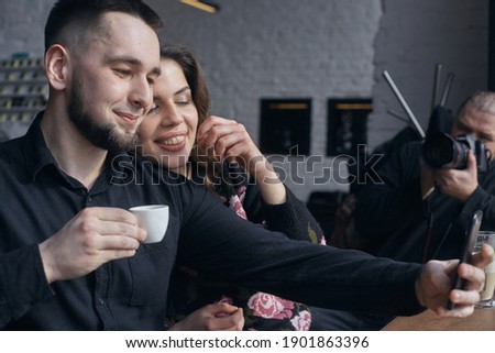 Couple taking a selfie in cafe