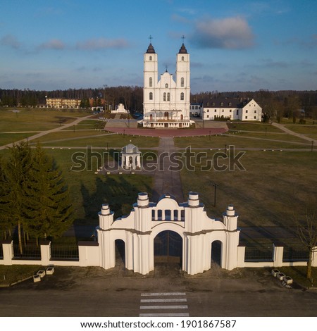 View from above of Aglona Roman Catholic Basilica of the Assumption of the Blessed Virgin Mary. Latvian landmark. Beautiful forest.