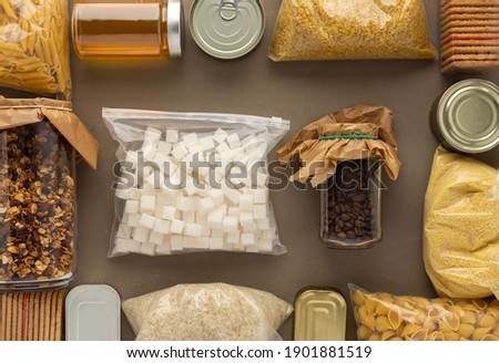 Home food supplies, necessary food for the period of quarantine and isolation, the concept of stay at home, canned food , various pasta and flour, sugar and cookies, top view