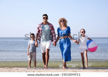 Happy family at beach on sunny summer day