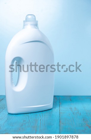 white bottles without labels with cleaning agent on a blue background