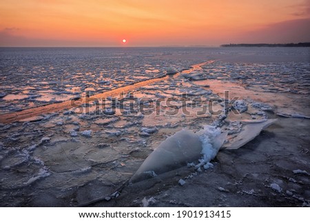 Winter landscape with sunset sky and frozen river. Daybreak

