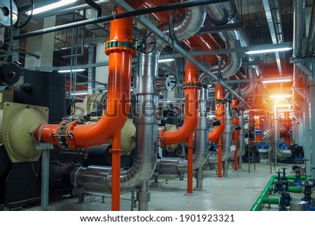 Industrial interior chiller and boiler HVAC heating ventilation air conditioning system and pipping line of industrial construction at boiler pump room system in the factory Royalty-Free Stock Photo #1901923321