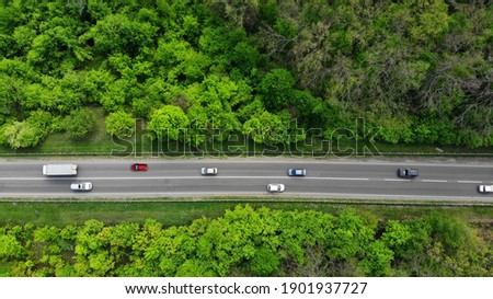 Aerial. Traffic on the intercity highway between the natural parkland. Top view from drone. Royalty-Free Stock Photo #1901937727