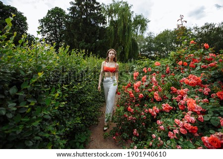 girl walking in the rose garden