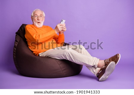 Full length profile portrait of impressed handsome man wear pants shoes isolated on purple color background