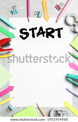 Sheet of paper with word Start and stationery on grey table, flat lay. Space for text