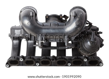 Intake manifold plastic housing with a system for adjusting the air flow to the engine. Repair and replacement of spare parts of vehicles in a car service. Royalty-Free Stock Photo #1901992090