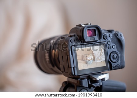 Close up professional digital camera on a tripod on a blurred background. The concept of technology for working with photos and videos.