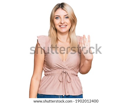 Young caucasian woman wearing casual clothes showing and pointing up with fingers number four while smiling confident and happy. 