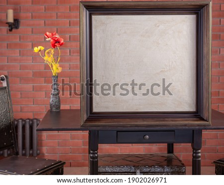 Frame with blank white canvas on table