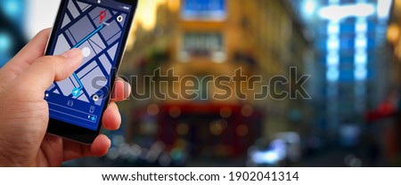 Close up of Tourist using GPS map navigation on smartphone application screen for direction to destination address in the city with travel and technology concept.    