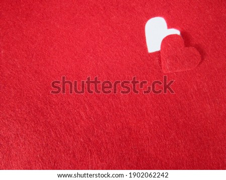                                white heart shape cut out in the corner of a red background